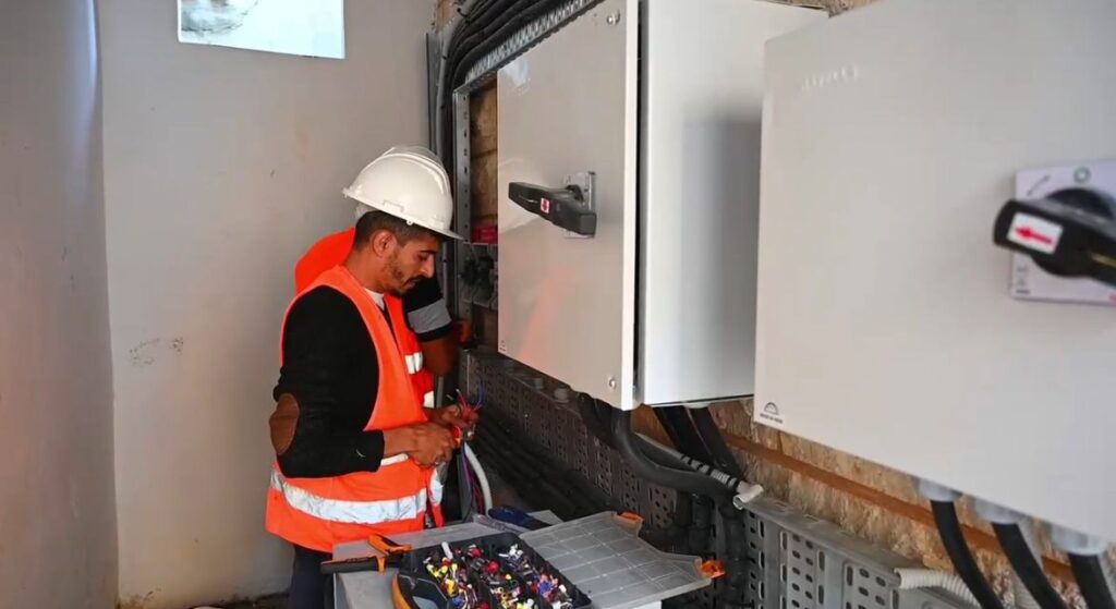 Technician performing maintenance on solar energy system for Beta EPC Solutions